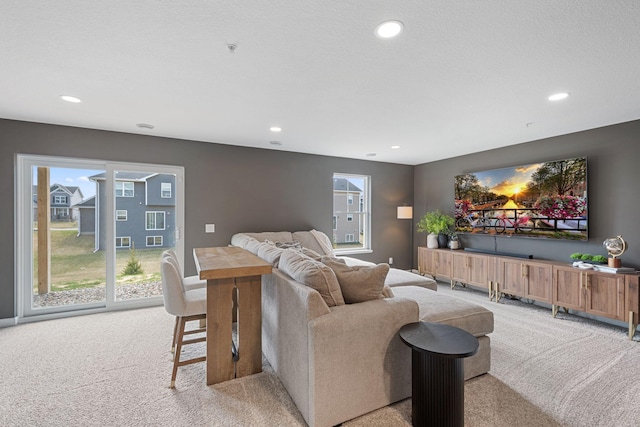 living room with light colored carpet and recessed lighting