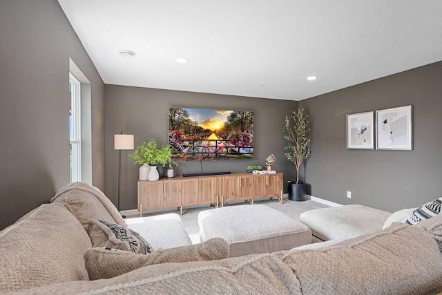 carpeted living area featuring baseboards and recessed lighting