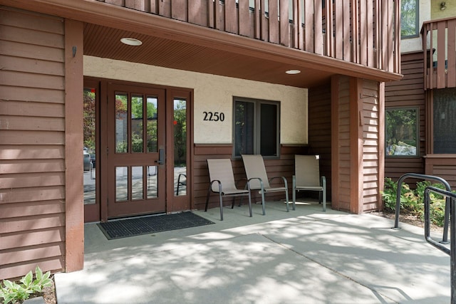 view of exterior entry with a porch
