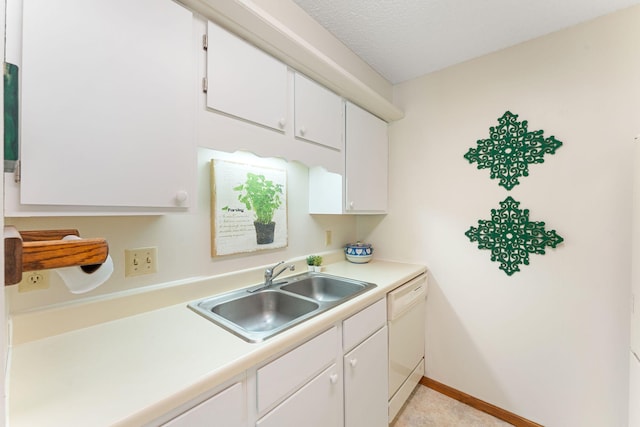 kitchen with a sink, white dishwasher, light countertops, white cabinets, and a textured ceiling