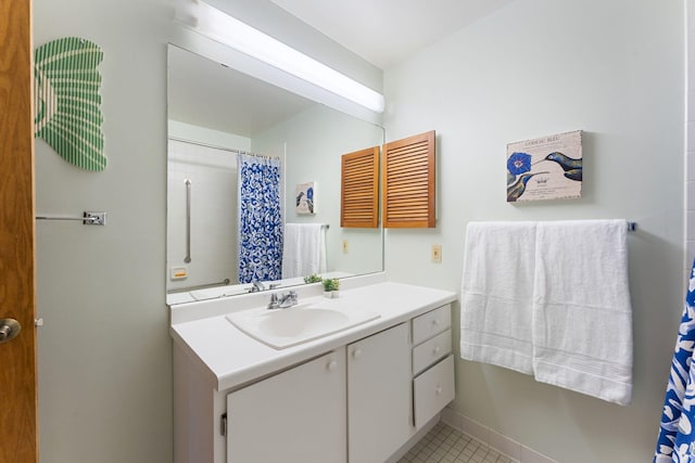bathroom featuring vanity, a shower with curtain, tile patterned floors, and baseboards
