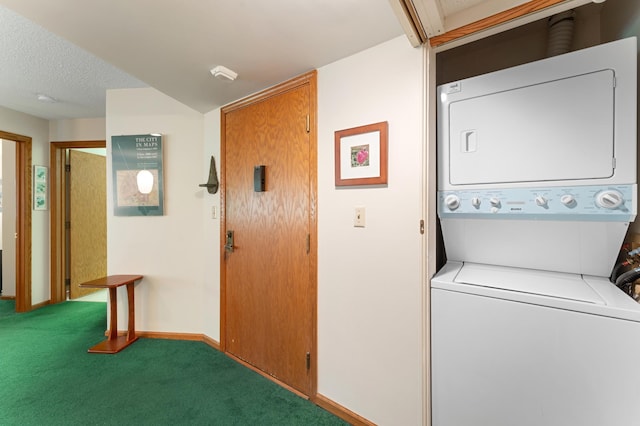 clothes washing area with stacked washer / dryer, carpet flooring, baseboards, and a textured ceiling