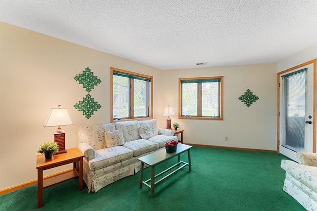 carpeted living room with a textured ceiling and baseboards
