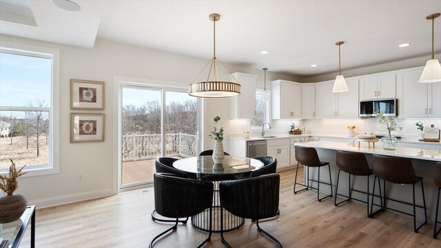 2009 Lusitano St, Shakopee, MN 55379 - dining space with light wood-style floors, plenty of natural light, baseboards, and recessed lighting