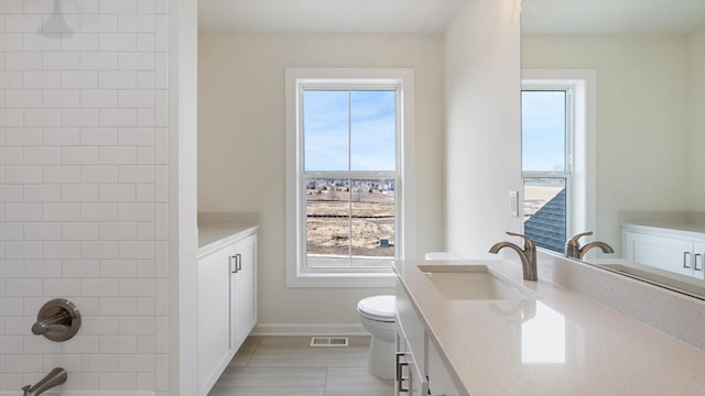 full bath with vanity, toilet, bathtub / shower combination, and baseboards