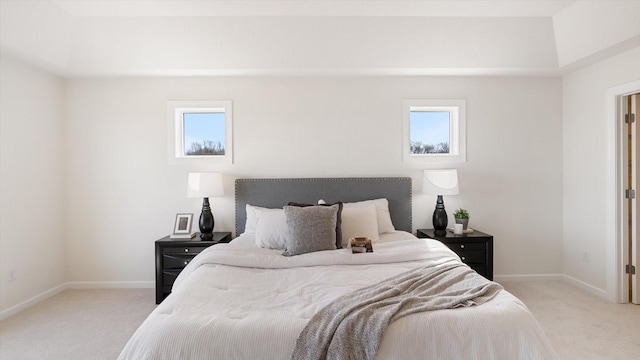 bedroom featuring light carpet, baseboards, and multiple windows