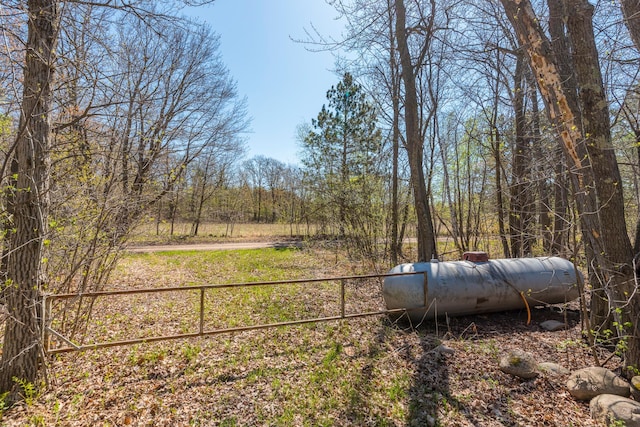 view of yard with a view of trees and fence