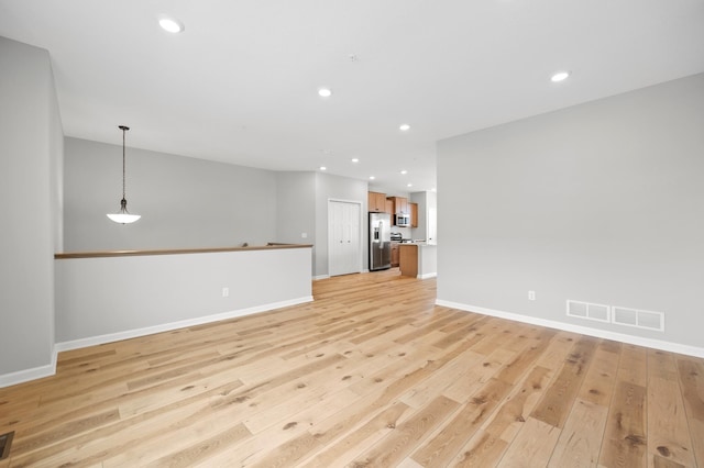 6750 Wildflower Way, Minnetrista, MN 55331 - unfurnished living room with light wood finished floors, baseboards, and recessed lighting