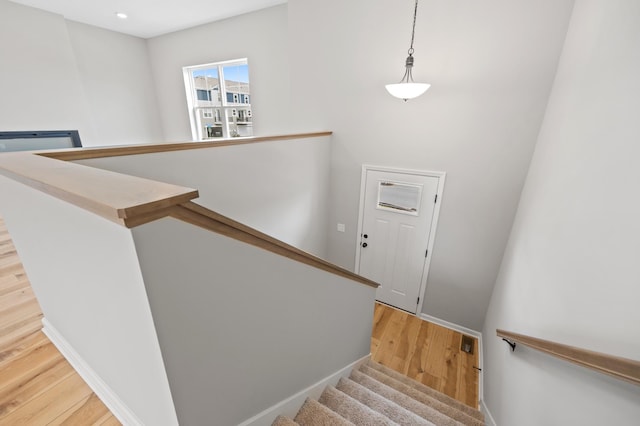 6750 Wildflower Way, Minnetrista, MN 55331 - stairway featuring wood finished floors, baseboards, and recessed lighting