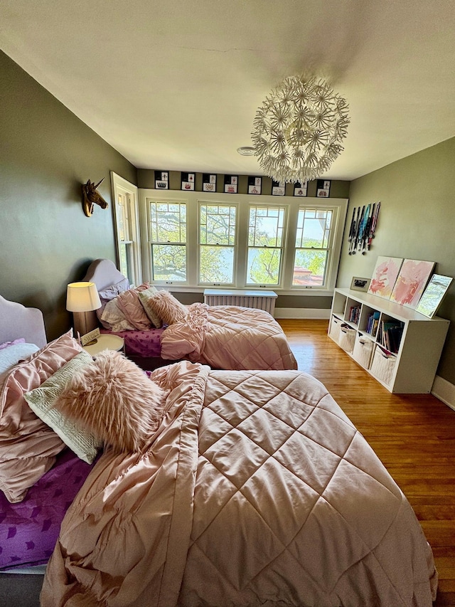 bedroom featuring wood finished floors and baseboards