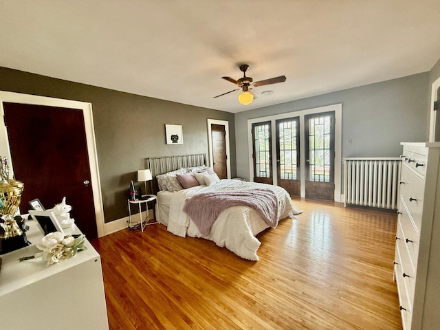 bedroom featuring access to exterior, light wood-type flooring, ceiling fan, and baseboards