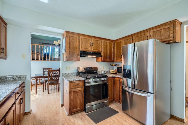456 Ridge Ct, Chaska, MN 55318 - kitchen featuring appliances with stainless steel finishes, under cabinet range hood, light wood-style flooring, and brown cabinetry