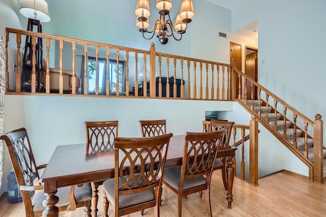 456 Ridge Ct, Chaska, MN 55318 - dining room with wood finished floors, a chandelier, stairs, and baseboards