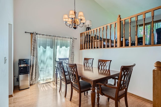 456 Ridge Ct, Chaska, MN 55318 - dining room featuring a chandelier, wood finished floors, a towering ceiling, and baseboards