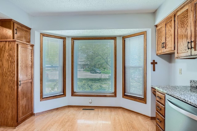 456 Ridge Ct, Chaska, MN 55318 - kitchen featuring dishwasher, light wood-style flooring, brown cabinetry, and baseboards