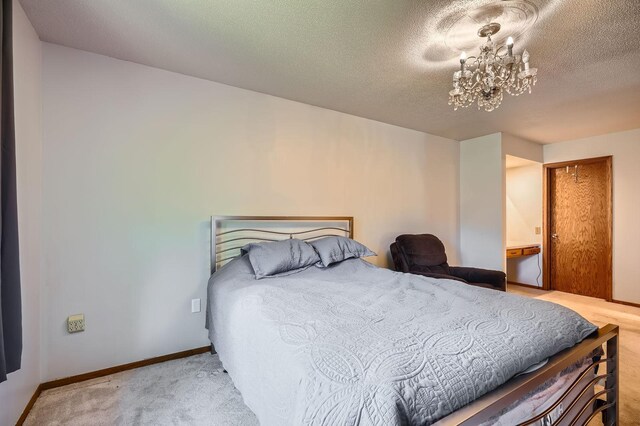 456 Ridge Ct, Chaska, MN 55318 - bedroom featuring a chandelier, carpet floors, a textured ceiling, and baseboards