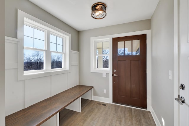 mudroom with wood finished floors and baseboards