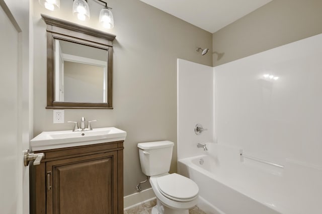 full bathroom featuring toilet, vanity, tub / shower combination, and baseboards