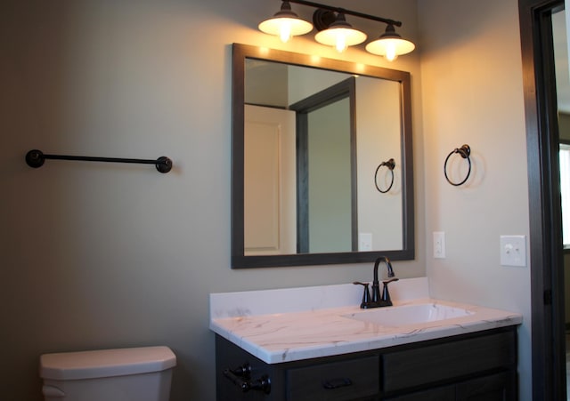bathroom featuring toilet and vanity