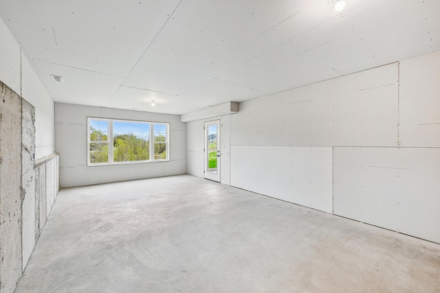spare room featuring unfinished concrete floors
