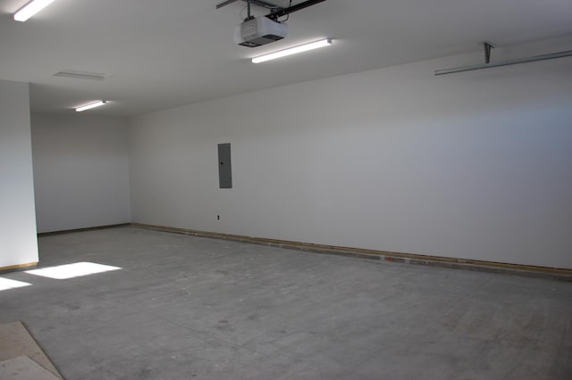 garage featuring electric panel, baseboards, and a garage door opener