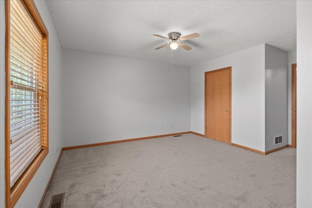 1960 Pika Trl Unit C, River Falls, WI 54022 - unfurnished room with carpet flooring, ceiling fan, a textured ceiling, and baseboards