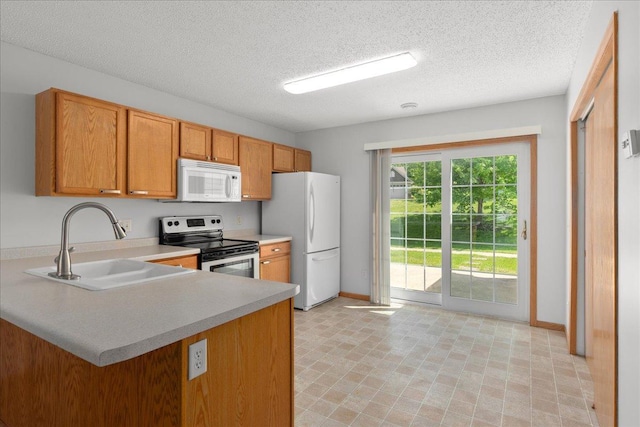 1960 Pika Trl Unit C, River Falls, WI 54022 - kitchen featuring white appliances, a sink, light countertops, a textured ceiling, and baseboards