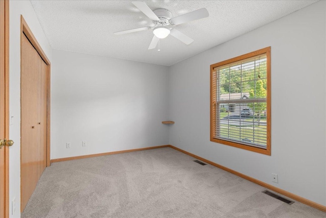 1960 Pika Trl Unit C, River Falls, WI 54022 - unfurnished bedroom with carpet flooring, a textured ceiling, baseboards, a closet, and ceiling fan