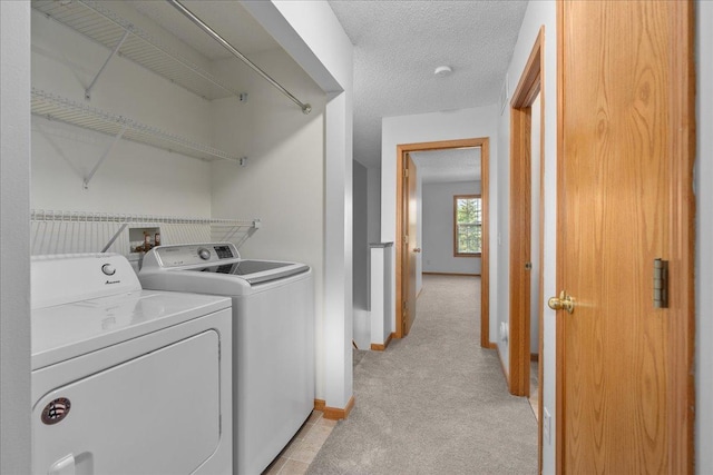 1960 Pika Trl Unit C, River Falls, WI 54022 - laundry room with washing machine and clothes dryer, baseboards, light carpet, and a textured ceiling