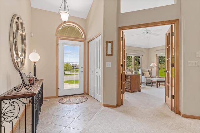 foyer featuring baseboards and ceiling fan