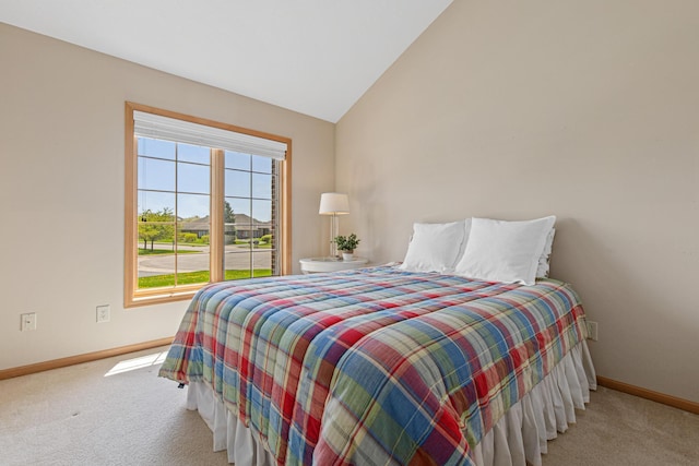 bedroom with baseboards, carpet, and vaulted ceiling