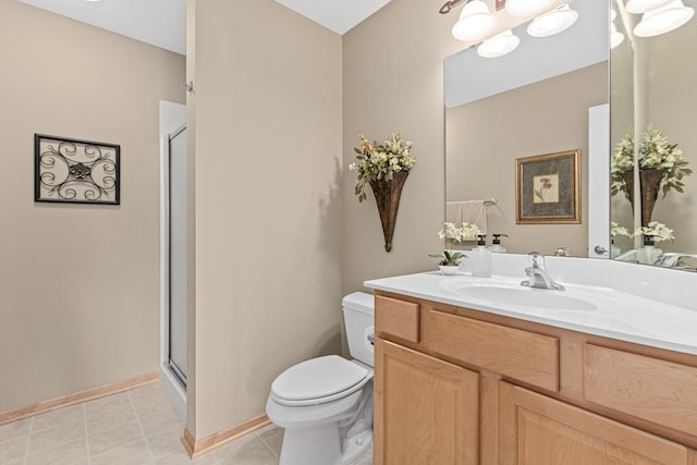 bathroom with toilet, a stall shower, vanity, baseboards, and a chandelier