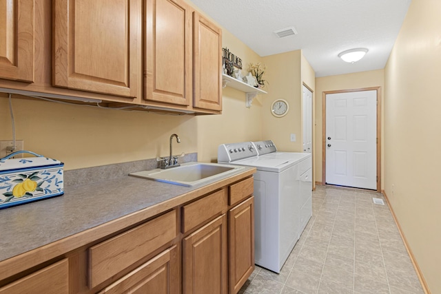 laundry area with washing machine and clothes dryer, cabinet space, light tile patterned floors, and baseboards