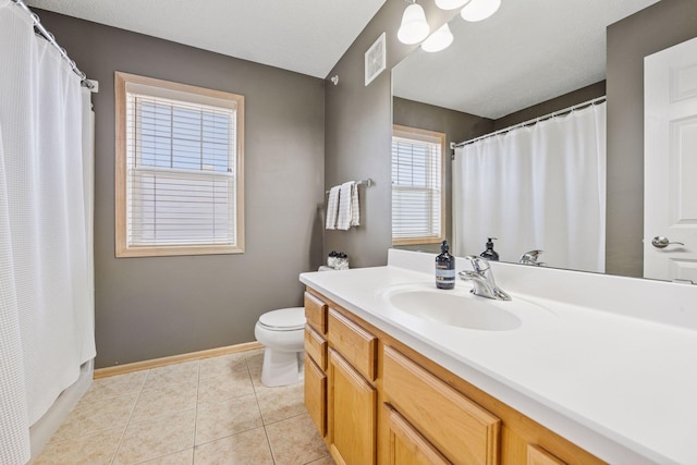 bathroom featuring toilet, vanity, visible vents, tile patterned flooring, and baseboards
