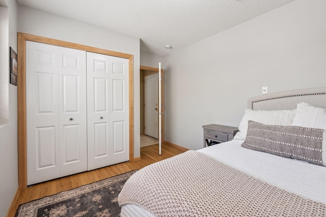 bedroom with a closet and wood finished floors