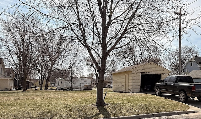 321 Western Ave, Madison, MN 56256 - view of grassy yard featuring a garage, an outdoor structure, and a residential view