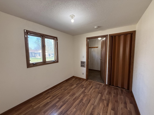 321 Western Ave, Madison, MN 56256 - spare room featuring dark wood-style flooring and a textured ceiling