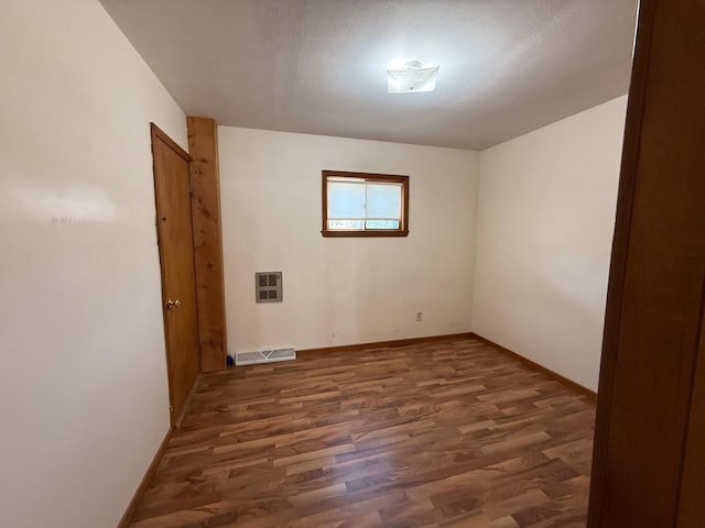 321 Western Ave, Madison, MN 56256 - spare room featuring wood finished floors, heating unit, and baseboards