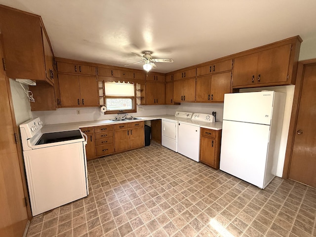 321 Western Ave, Madison, MN 56256 - kitchen with white appliances, separate washer and dryer, brown cabinets, and ceiling fan