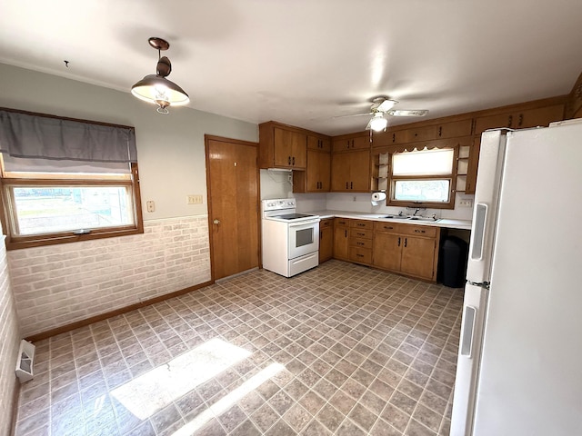 321 Western Ave, Madison, MN 56256 - kitchen with white appliances, healthy amount of natural light, light countertops, a sink, and brick wall