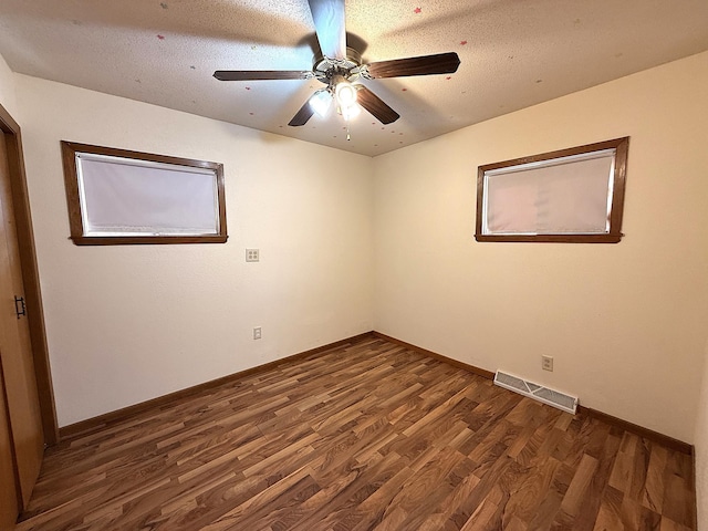 321 Western Ave, Madison, MN 56256 - empty room featuring dark wood-type flooring, baseboards, and a ceiling fan