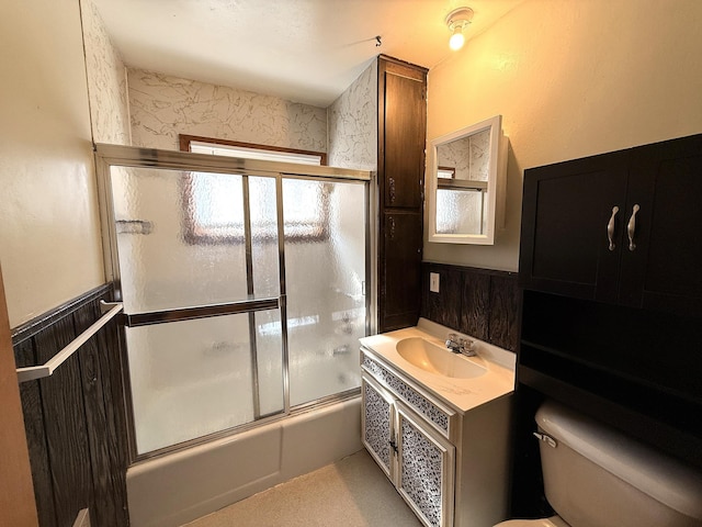 321 Western Ave, Madison, MN 56256 - bathroom with toilet, shower / bath combination with glass door, a wainscoted wall, and vanity