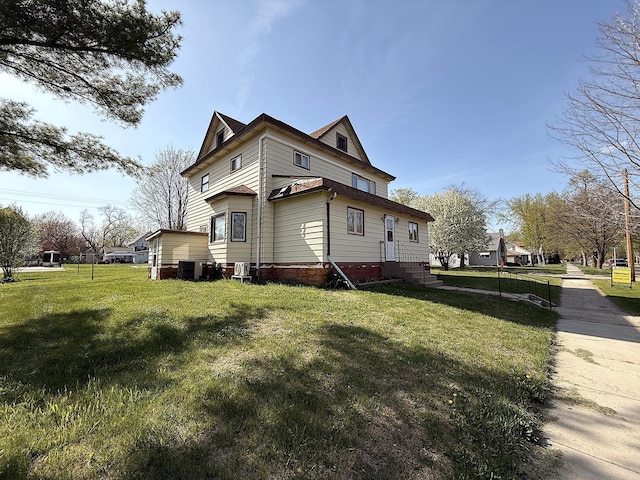 321 Western Ave, Madison, MN 56256 - view of side of home featuring a lawn, entry steps, and central air condition unit