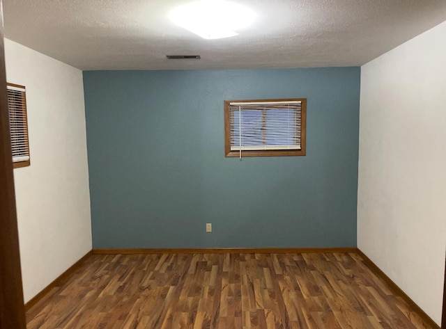 321 Western Ave, Madison, MN 56256 - empty room featuring wood finished floors, baseboards, and a textured ceiling