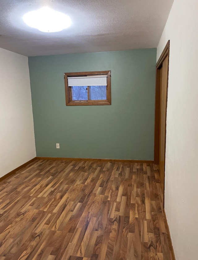 321 Western Ave, Madison, MN 56256 - empty room featuring wood finished floors, baseboards, and a textured ceiling
