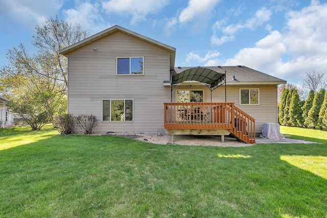 back of house with a deck and a yard