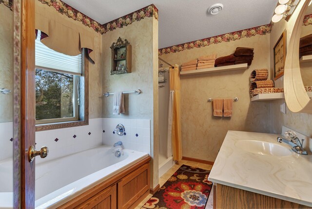 full bath featuring a stall shower, a garden tub, vanity, and tile patterned floors