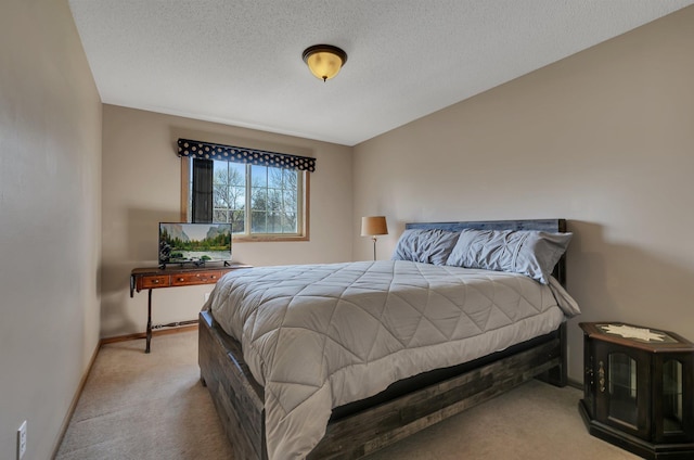 carpeted bedroom with baseboards and a textured ceiling