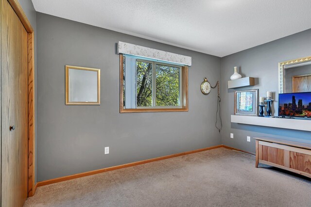 unfurnished bedroom with carpet floors and baseboards