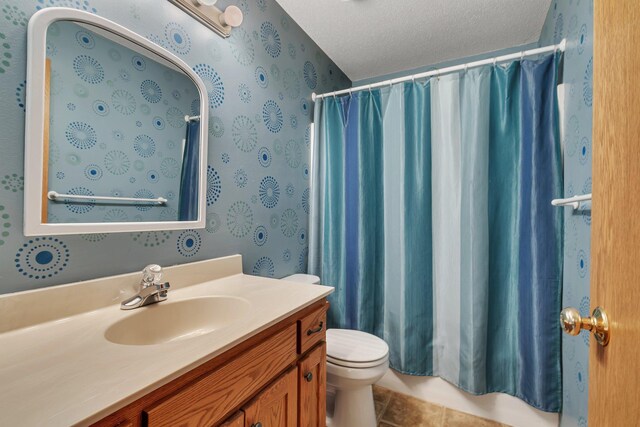 bathroom featuring toilet, wallpapered walls, vanity, tile patterned flooring, and shower / bath combo with shower curtain